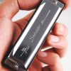 Silver Harmonica in hand